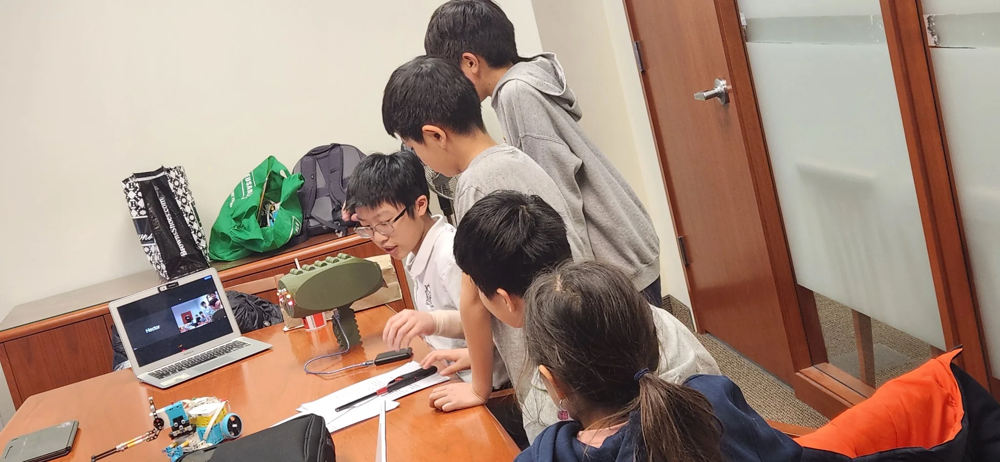Students consulting on an engineering project with a university professor