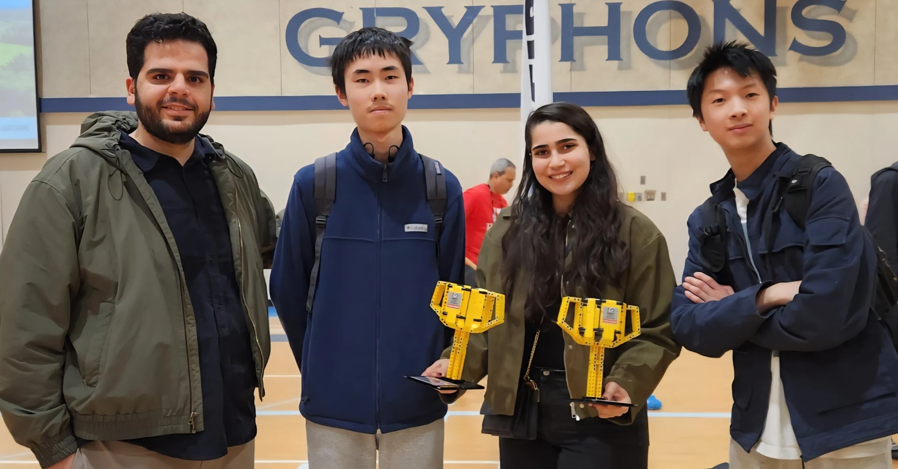 Robotics mentors and students at a competition